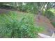 View of backyard, including mature trees, manicured shrubbery and an iron fence at 12212 Wild Iris Way # 106, Orlando, FL 32837