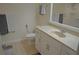 Bright bathroom featuring a white vanity with a sink, a mirror, and neutral-colored tiles at 12212 Wild Iris Way # 106, Orlando, FL 32837