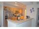 Open kitchen with light wood cabinets, stainless steel appliances, and a breakfast bar at 12212 Wild Iris Way # 106, Orlando, FL 32837