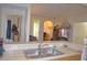 Open-concept kitchen with stainless steel sink overlooking the living area and lots of natural light at 12212 Wild Iris Way # 106, Orlando, FL 32837