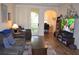 Inviting living room featuring hardwood floors, balcony access, and an adjacent office space at 12212 Wild Iris Way # 106, Orlando, FL 32837