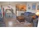 Open concept living room with wood floors, a dining area, and kitchen at 12212 Wild Iris Way # 106, Orlando, FL 32837