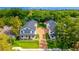 Aerial view showcasing two modern homes with landscaped yards and long driveways lined with green grass at 1321 Weber St, Orlando, FL 32803