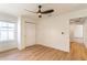 This bedroom offers a modern ceiling fan, sleek wood floors, and natural light from a large window at 1321 Weber St, Orlando, FL 32803