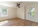 Bright bedroom featuring light hardwood floors, two windows, and neutral walls allowing for flexible decorating at 1321 Weber St, Orlando, FL 32803