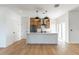 Modern kitchen featuring an island with pendant lighting, wood cabinets, and stainless steel appliances at 1321 Weber St, Orlando, FL 32803