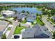 Stunning aerial view of homes nestled near a serene lake with lush landscaping and winding streets at 13347 Gabor Ave, Orlando, FL 32827