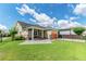 Beautiful backyard with green lawn, patio, and iron fence at 13347 Gabor Ave, Orlando, FL 32827