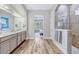 Modern bathroom with double vanity, walk-in shower, and wood-look tile flooring at 13347 Gabor Ave, Orlando, FL 32827