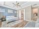 Spacious main bedroom features a tray ceiling, ceiling fan, and a view of the bathroom and walk-in closet at 13347 Gabor Ave, Orlando, FL 32827