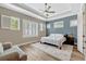 The primary bedroom features a trey ceiling, fan, and an array of windows with natural light at 13347 Gabor Ave, Orlando, FL 32827