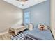 ' bedroom with two twin beds, ceiling fan, and blue accent wall at 13347 Gabor Ave, Orlando, FL 32827