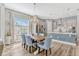 Elegant dining area with hardwood floors, a chandelier, and a view into the modern kitchen at 13347 Gabor Ave, Orlando, FL 32827