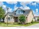 Charming two-story home featuring a manicured lawn, stone accents, and a welcoming front porch in a suburban setting at 13347 Gabor Ave, Orlando, FL 32827