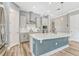 Bright kitchen with stainless steel appliances, range hood, white cabinets, and a large island at 13347 Gabor Ave, Orlando, FL 32827