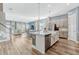 Spacious open-concept kitchen with a large island, modern appliances, and seamless flow into the living area at 13347 Gabor Ave, Orlando, FL 32827