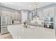 Modern kitchen features stainless steel appliances, white cabinets, and a large quartz island at 13347 Gabor Ave, Orlando, FL 32827