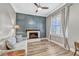 Cozy living room showcasing a modern fireplace, paneled accent wall, hardwood floors, and abundant natural light at 13347 Gabor Ave, Orlando, FL 32827