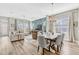 Bright and airy living room featuring stylish furnishings, a dining area, and large windows offering ample natural light at 13347 Gabor Ave, Orlando, FL 32827