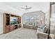 Comfortable living room featuring a large window, ceiling fan, and built-in shelving at 13347 Gabor Ave, Orlando, FL 32827