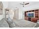 Cozy living room with ceiling fan, built-in shelving, and plush gray sofas at 13347 Gabor Ave, Orlando, FL 32827