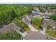 Aerial view of suburban home with pool and lush landscaping at 13609 Sky Blue Ct, Orlando, FL 32828