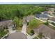 This aerial view showcases a well-maintained home with a pool and lush landscaping in a desirable neighborhood at 13609 Sky Blue Ct, Orlando, FL 32828