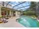 Backyard view of covered pool with patio and screen enclosure at 13609 Sky Blue Ct, Orlando, FL 32828