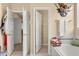 Bathroom with double doors and a drop in tub that is surrounded by white tile at 13609 Sky Blue Ct, Orlando, FL 32828