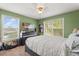 Guest bedroom with a bed, dresser, and two windows for natural light at 13609 Sky Blue Ct, Orlando, FL 32828