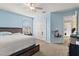 A cozy bedroom with blue walls, a platform bed, closet, and window at 13609 Sky Blue Ct, Orlando, FL 32828