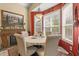 Cozy dining area with bright red accent wall features ample natural light and a decorative fireplace at 13609 Sky Blue Ct, Orlando, FL 32828