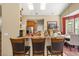 Breakfast bar provides a casual seating area with views into the bright and airy kitchen and dining area at 13609 Sky Blue Ct, Orlando, FL 32828