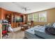 A spacious living room with large TV, wooden furniture, and a comfortable couch at 13609 Sky Blue Ct, Orlando, FL 32828