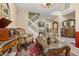 Elegant living room showcases a staircase, tile floors, and classic furniture with ornate detailing at 13609 Sky Blue Ct, Orlando, FL 32828