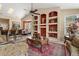 Open-concept living room boasts custom built-in shelves, high ceilings, and views into the dining area at 13609 Sky Blue Ct, Orlando, FL 32828