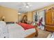 Main bedroom with a four-poster bed, a ceiling fan, and closet with sliding doors at 13609 Sky Blue Ct, Orlando, FL 32828