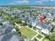 Stunning aerial view of home with red pin marker, nestled among tree-lined streets, with nearby green space at 13913 Hahn Ln, Orlando, FL 32827