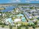 Aerial view featuring multiple sparkling pools, lush landscaping, and recreational facilities in the community at 13913 Hahn Ln, Orlando, FL 32827