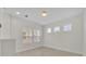Bright bedroom with three windows, featuring white walls and light wood flooring at 13913 Hahn Ln, Orlando, FL 32827