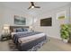 Cozy bedroom features plush bedding, modern decor, and mounted television at 13913 Hahn Ln, Orlando, FL 32827