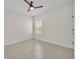 Clean bedroom with light-colored walls and wood-look flooring with a ceiling fan and a window at 13913 Hahn Ln, Orlando, FL 32827