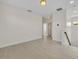 Spacious bonus room with light wood floors, leading to the staircase, with neutral colored walls at 13913 Hahn Ln, Orlando, FL 32827