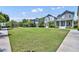 Lush green lawn in a residential community with sidewalks, mature trees, and picturesque homes at 13913 Hahn Ln, Orlando, FL 32827