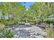 Picturesque community walkway features lush landscaping, mature trees, benches, and inviting ambiance for relaxation at 13913 Hahn Ln, Orlando, FL 32827