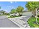 Home exterior featuring a large driveway leading to a two car garage surrounded by mature trees at 13913 Hahn Ln, Orlando, FL 32827