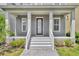 Inviting front porch with sturdy columns, fresh gray stairs, and a sleek black front door with house number at 13913 Hahn Ln, Orlando, FL 32827
