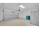Spacious garage with automatic door opener, painted floors and walls, and ample space for cars at 13913 Hahn Ln, Orlando, FL 32827