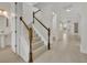 Elegant staircase with wood railings and white risers leading to spacious living area at 13913 Hahn Ln, Orlando, FL 32827
