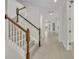 Elegant staircase with wood railings and white risers, leading to a brightly lit hallway at 13913 Hahn Ln, Orlando, FL 32827